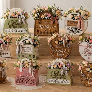 May include: A collection of floral arrangements in decorative containers, perfect for Mother's Day. The arrangements feature pastel-colored flowers and are displayed in various shapes, including handbags and hearts. Some containers have text like "Best Mother Ever" and "Happy Mother's Day".