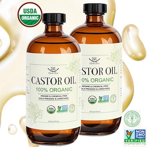 May include: Two amber glass bottles of castor oil with black caps. Each bottle has a white label with the text "CASTOR OIL 100% ORGANIC" and "STOR OIL 100% ORGANIC". The bottles are labeled as hexane and chemical free, cold pressed and unrefined. The bottles are 16.5 fl oz / 473 ml.