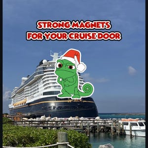 May include: A green cartoon chameleon wearing a Santa hat is featured in front of a cruise ship. The text "STRONG MAGNETS FOR YOUR CRUISE DOOR" is displayed above the chameleon. The ship is docked near a pier with a blue sky and water in the background.