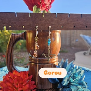 May include: A set of three ceramic mugs with a speckled, matte finish. The mugs are in shades of cream, light gray, and dark gray. Each mug has a simple, minimalist design and a rounded handle.