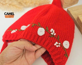 Rode gebreide babymuts: handgeborduurde pasgeboren babymutsje met bloemen