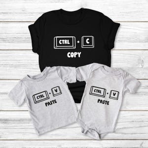 May include: Black t-shirt with "CTRL + C COPY" text, and two gray shirts with "CTRL + V PASTE" text. The shirts are short-sleeved and made of a soft material. The design is a computer keyboard command.