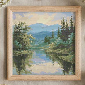 以下が含まれることがあります： 木製のフレームに入ったクロスステッチの風景画は、木々や山々のある穏やかな湖の景色を描いています。 アートワークは明るい木製のフレームに入っており、木製のボタンと白と黄色の花の小枝に囲まれています。 アートワークはStitchHaus Studioのものです。