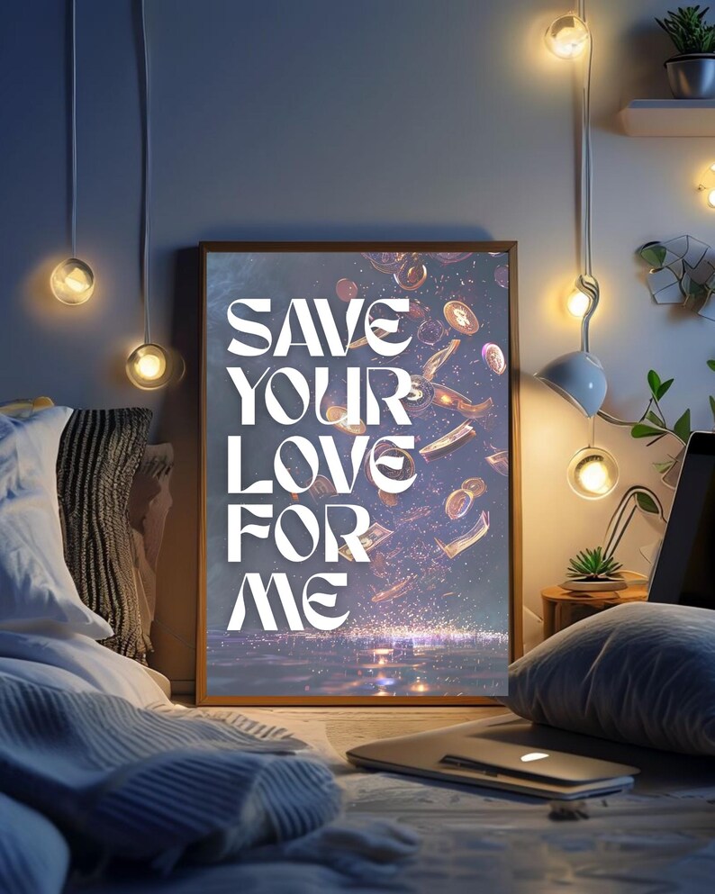 May include: A framed art print with the text "SAVE YOUR LOVE FOR ME" in white, with falling money and coins. The artwork is set in a bedroom with soft lighting and a laptop.