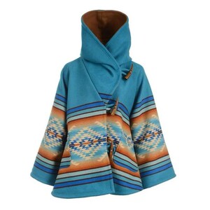May include: A turquoise hooded poncho with a Southwestern-inspired pattern in shades of orange, blue, and cream. The poncho features wooden toggle closures and a brown interior lining. This outerwear garment is designed for warmth and style.