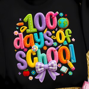 May include: Black sweatshirt with a colorful, textured graphic that reads "100 days of school." The design includes a globe, pencils, flowers, and a bow. The numbers and letters are in various bright colors.
