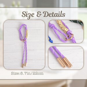 May include: A lavender rope leash with gold-colored accents. The leash features gold-colored square beads spelling out a name, and gold-colored metal tips. The size is 8.7 inches or 22cm.
