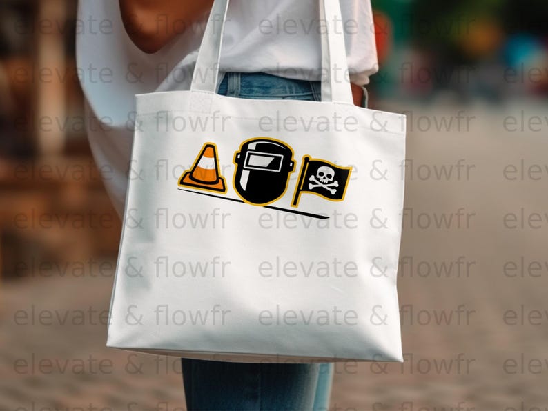 White tote bag with black and orange welding mask and skull crossbones graphic.