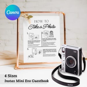 May include: A copper-colored metal frame holds a white sign with instructions on how to take a photo. A silver and black Instax Mini Evo camera with a black strap is on the right. The text on the sign reads "How to Take a Photo."