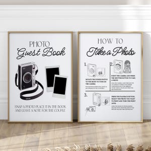 Può includere: Due stampe incorniciate con cornici color oro. La stampa a sinistra dice "PHOTO Guest Book" con un'illustrazione della fotocamera e istruzioni. La stampa a destra dice "HOW TO Take a Photo" con passaggi numerati e illustrazioni.