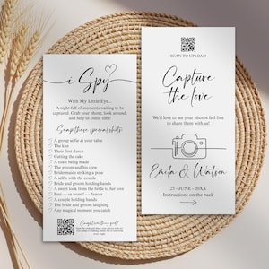 May include: Two white cards with black calligraphy text, designed for a wedding. One card says "i Spy" with a list of photo prompts. The other says "Capture the Love" with a camera graphic and a QR code.