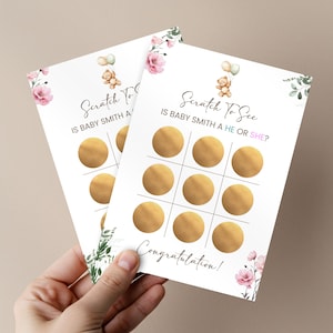 May include: Two baby shower scratch-off cards with a floral and teddy bear design. The cards read "Scratch To See Is Baby Smith A He or She?" and "Congratulations!" Each card has nine gold scratch-off circles.