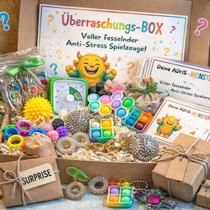 Op de afbeelding: Een doos vol met diverse kleurrijke anti-stress speelgoed, waaronder pop-its, fidgetringen en een timer. De doos bevat verpakte cadeaus en kaarten met tekst. De tekst op de doos luidt "Überraschungs-BOX?" en "SURPRISE".