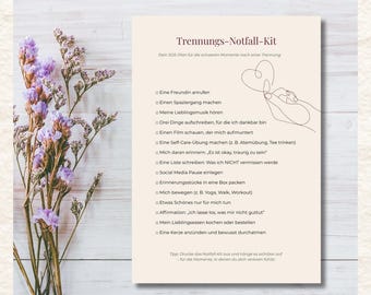 May include: A beige print with the text "Trennungs-Notfall-Kit" and a list of self-care activities. The print is decorated with a line drawing of a hand holding a heart. A sprig of purple flowers is on the left.