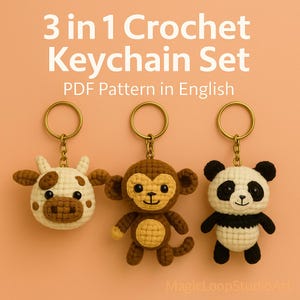 May include: Three crochet keychains: a cow, a monkey, and a panda. Each keychain is attached to a gold-colored ring. The cow is white with brown spots, the monkey is brown, and the panda is black and white. Text reads "3 in 1 Crochet Keychain Set PDF Pattern in English."
