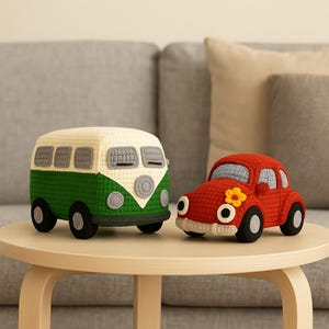 May include: Two handmade, stuffed toy vehicles: a green and cream-colored bus and a red car with a yellow flower. The bus has black wheels and gray windows. The car has black wheels and a cream-colored bumper. Both are on a light brown table.