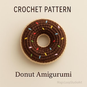 May include: Crochet pattern for a donut amigurumi. The donut is brown with colorful sprinkles and a tan border. The text "CROCHET PATTERN" and "Donut Amigurumi" are displayed above and below the donut.