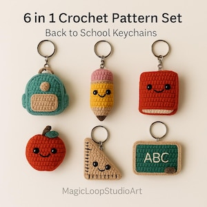 May include: A collection of six crocheted keychains in the shape of school-themed items. The keychains include a backpack, pencil, book, apple, protractor, and chalkboard with "ABC" on it. The keychains are in various colors, including teal, yellow, red, and tan.