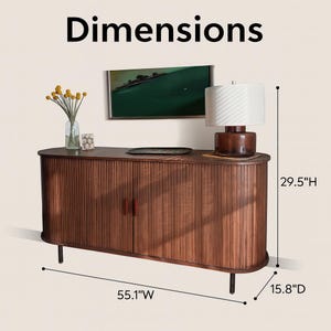 May include: A brown wooden cabinet with a ribbed front, two doors, and black legs. The cabinet is 55.1" wide, 29.5" high, and 15.8" deep. A lamp, artwork, and decorative items sit on top. The word "Dimensions" is at the top.