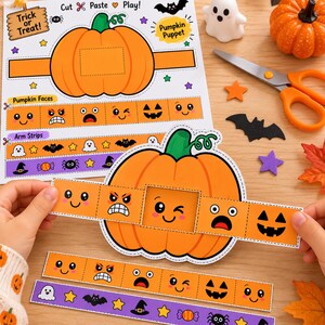 May include: A DIY Halloween pumpkin puppet craft sheet featuring a large orange pumpkin, various facial expressions, and decorative strips. The paper includes text such as Trick or Treat, Cut Paste Play, Pumpkin Puppet, Pumpkin Faces, and Arm Strips.