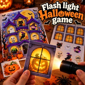 May include: A Flash light Halloween game set featuring a large haunted house illustration, a sheet of window cutouts, and individual character stickers. A black flashlight illuminates a square card showing a glowing jack-o'-lantern in a window.