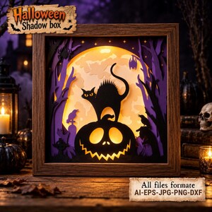 May include: A square wooden shadow box featuring a layered paper cut-out scene of a black cat perched on a jack-o'-lantern against a glowing yellow moon. The scene includes purple trees, a spider, and birds. Text at the top reads Halloween Shadow box.