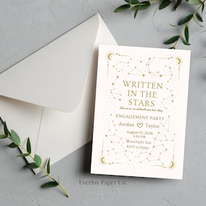 May include: An off-white engagement party invitation with gold constellation designs and the text "WRITTEN IN THE STARS." Includes details for Jordan and Taylor's party on August 15, 2026. An envelope is visible.