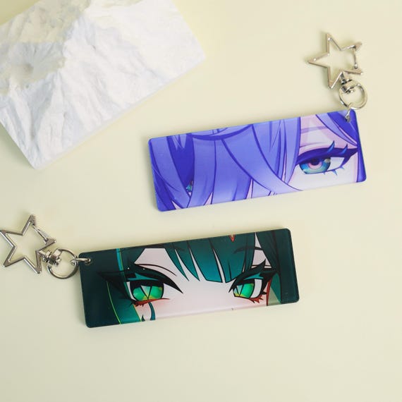Genshin Impact Nefer eye-strip keychain, featuring vibrant acrylic eyes and a sturdy metal ring for durable keychain or bag accessory use