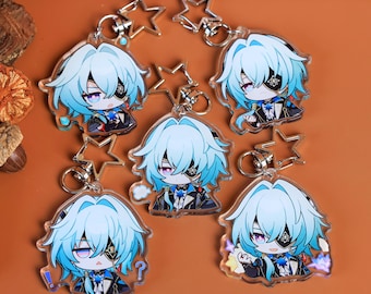 May include: Collection of acrylic keychains featuring a cartoon character with blue hair, an eyepatch, and a black outfit. Each keychain has a silver star-shaped charm and a metal ring for attachment. The background is a solid orange color.