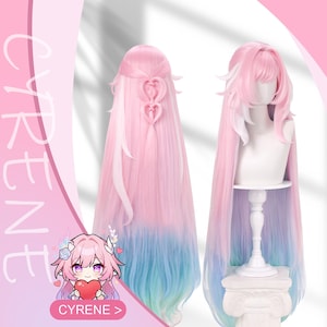 Puede incluir: Una peluca larga y en capas con un degradado de rosa, blanco y azul. La peluca presenta un accesorio para el cabello en forma de corazón y se muestra en una cabeza de maniquí. La palabra "CYRENE" es visible.