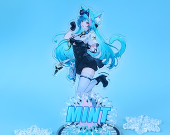 May include: A clear acrylic figure of an anime-style character with blue hair and a black and white outfit. The figure is on a base with the word "MINT" in blue. The figure is standing on a circular base with a black and silver design. Clear acrylic shapes are scattered around the base.