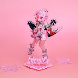 Puede incluir: Una figura de acrílico rosa de un personaje de estilo anime con cabello rosa, un halo y un atuendo blanco y rosa. La figura está sobre un soporte con el texto "Afterglow". El fondo es de color rosa liso.