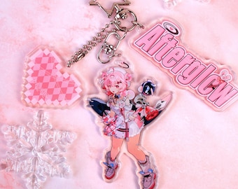 May include: An acrylic keychain featuring a star-shaped clasp, a pink heart charm with a checkered pattern, a clear snowflake charm, and a character charm with pink hair holding a bomb, alongside a pink text charm that reads Afterglow.