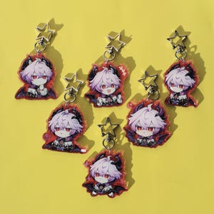 May include: Seven anime-style keychains featuring a character with lavender hair, red eyes, and black horns and wings. Each keychain has a star-shaped clasp. The keychains are on a yellow background.