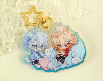 May include: A clear acrylic keychain featuring two anime-style characters with animal-like features. One character is a dog, the other a cat. The keychain has a gold star-shaped clasp and a gold ring. The characters are surrounded by small animal figures.