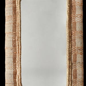 May include: A rectangular wall mirror featuring a thick, textured frame woven from natural fibres in alternating vertical stripes of light beige and tan. The inner edge of the frame is finished with a braided jute trim surrounding the glass surface.