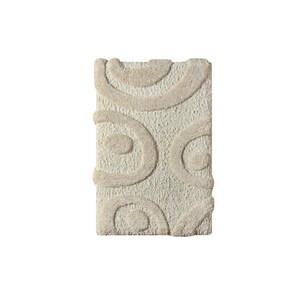 May include: Rectangular beige bath mat with a textured surface and raised, light beige, abstract circular patterns. The mat is designed for bathroom use and adds a touch of modern style.