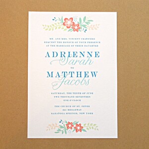 May include: A wedding invitation with a floral design in shades of pink, blue, and green. The invitation announces the marriage of Adrienne Sarah to Matthew Jacobs on Saturday, June 10th, 2017 at 1:00 PM at the Church of St. Peter in Saratoga Springs, New York.