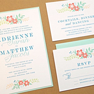 May include: Wedding invitation with a floral design in shades of pink, blue, and green. The invitation reads "Adrienne Sarah to Matthew Jacobs" and includes the date, time, and location of the wedding ceremony. The RSVP card includes a floral design and the text "Kindly reply by the twenty-ninth of April."