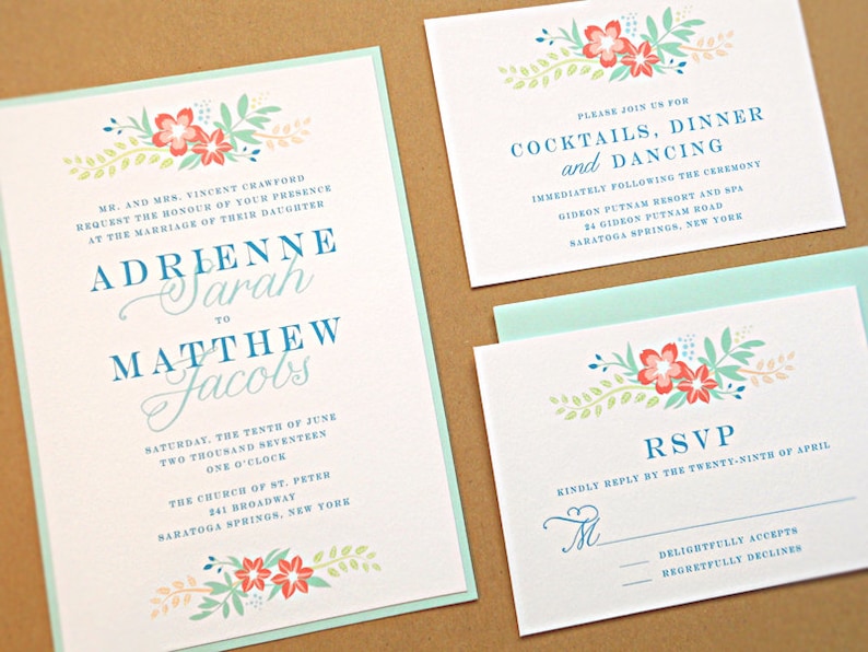 May include: Wedding invitation with a floral design in shades of pink, blue, and green. The invitation reads "Adrienne Sarah to Matthew Jacobs" and includes the date, time, and location of the wedding ceremony. The RSVP card includes a floral design and the text "Kindly reply by the twenty-ninth of April."