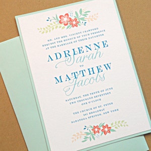 May include: A wedding invitation with a light blue border and floral accents. The invitation is for the wedding of Adrienne Sarah to Matthew Jacobs on Saturday, June 10th, 2017 at 1:00 PM at the Church of St. Peter in Saratoga Springs, New York.