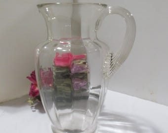 Ornate Vintage Glass Pitcher with Paneled Sides and Decorative Handle