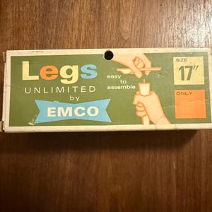 May include: Vintage box for "Legs Unlimited by EMCO." The box is green and white with the text "Legs Unlimited" in orange and blue. It features an illustration showing how to assemble the legs. The size is 17 inches.