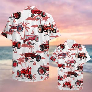 May include: White button-down shirt featuring a repeating pattern of red vintage tractors and palm trees. The tractors have various model numbers and years printed on them. The shirt is short-sleeved.