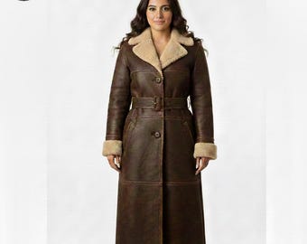 May include: A long, brown leather coat with a beige shearling collar and cuffs. The coat features a belted waist, button closures, and a classic design. The coat is a stylish outerwear option.