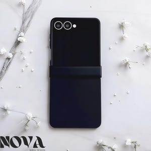 May include: A black smartphone case with a matte finish, featuring a camera module with two lenses and a flash. The case is designed to fold in half. The word "NOVA" is printed at the bottom.