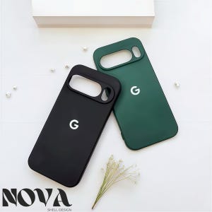 May include: Two phone cases, one black and one green, are displayed on a white surface. Each case has a cutout for the camera and a white "G" logo. The cases are from "NOVA SHELL DESIGN".