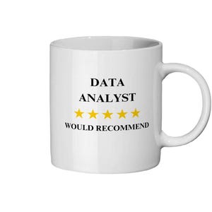 May include: White ceramic mug featuring the text "DATA ANALYST" in black, five gold stars, and the words "WOULD RECOMMEND". The mug has a curved handle.