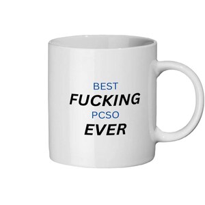 May include: White ceramic mug with black and blue text that reads "BEST FUCKING PCSO EVER". The mug has a curved handle and a cylindrical shape.