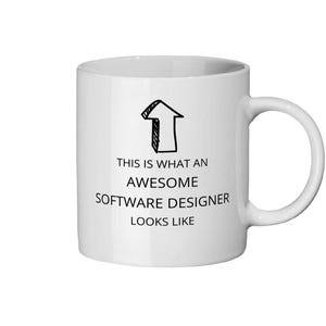 May include: White ceramic mug with a black arrow graphic and the text "THIS IS WHAT AN AWESOME SOFTWARE DESIGNER LOOKS LIKE". The mug has a curved handle.